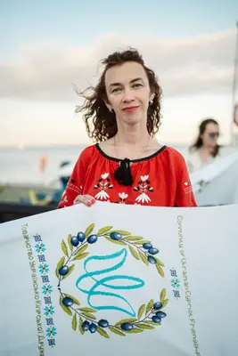A panel with an embroidered wreath and trident