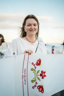 A participant holds her embroidered panel
