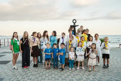 Children and teenagers of the Larnaca community by the anchor monument